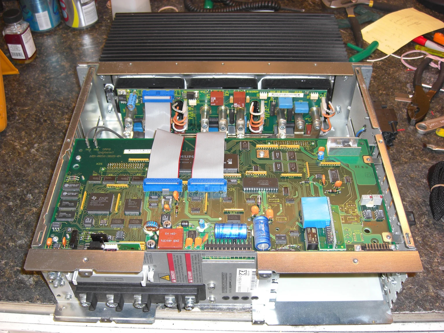 Litco repair reference of a DDS02.1-A150-D drive opened on the bench, with its original tag visible
