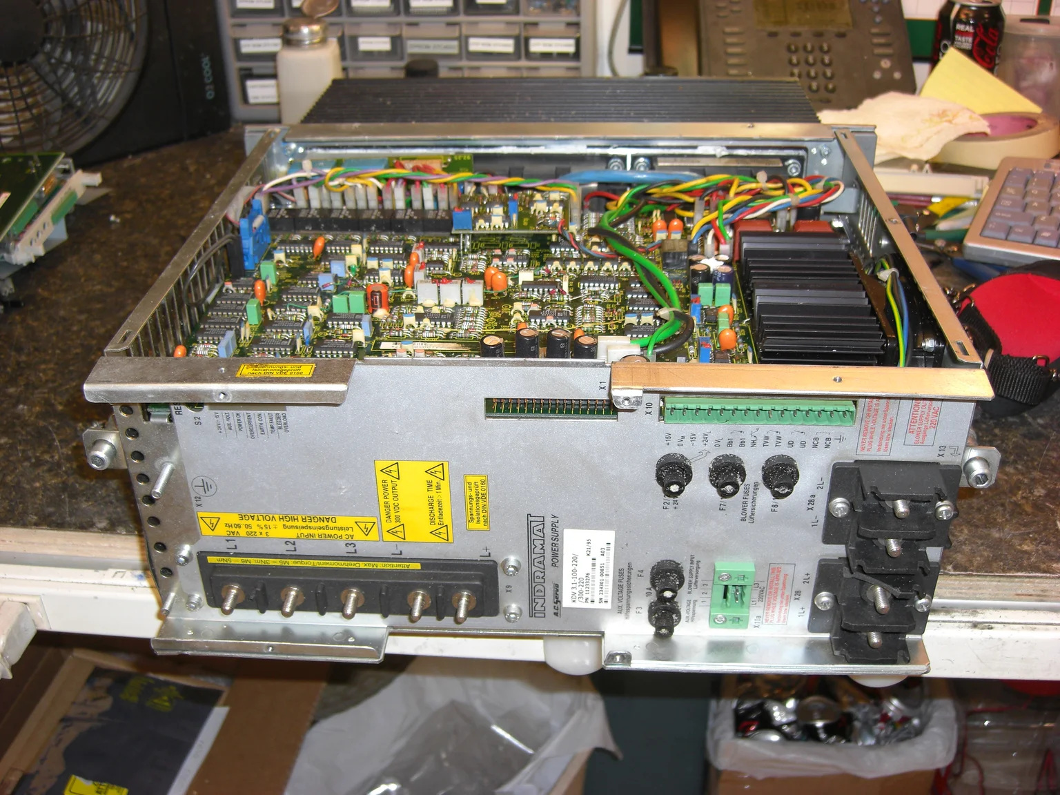 Litco KDV3.1-100-220/300-220 power supply open on a repair bench with its factory tag visible